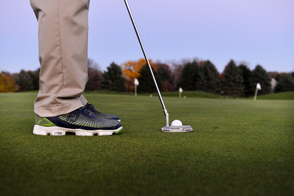 Golfer putting on golf course